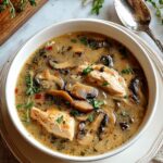 Bowl of Rotisserie Chicken Mushroom Soup garnished with fresh thyme