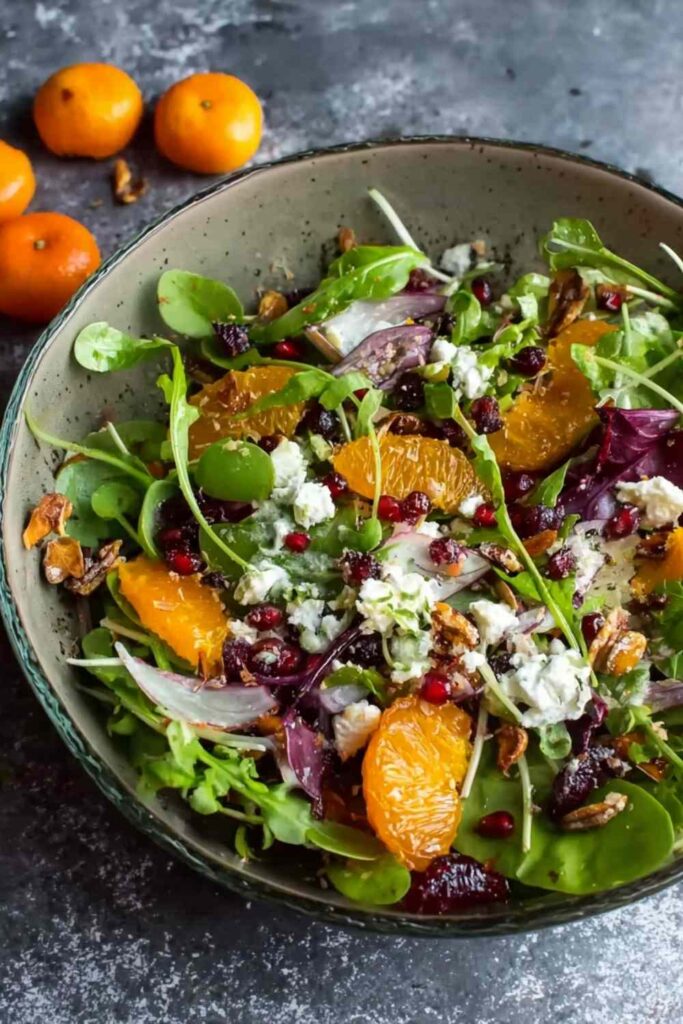 Winter salad with oranges pomegranate feta cheese and candied pecans