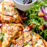 BBQ chicken quesadillas sliced into wedges on white plate with melted cheese