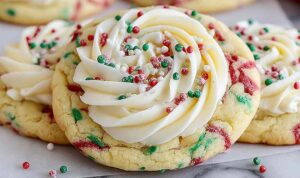 Soft cake batter cookies with rainbow sprinkles and white chocolate chips on cooling rack