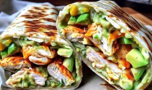 Chicken Avocado Ranch Burritos cut in half showing seasoned chicken filling with creamy ranch sauce and fresh avocado
