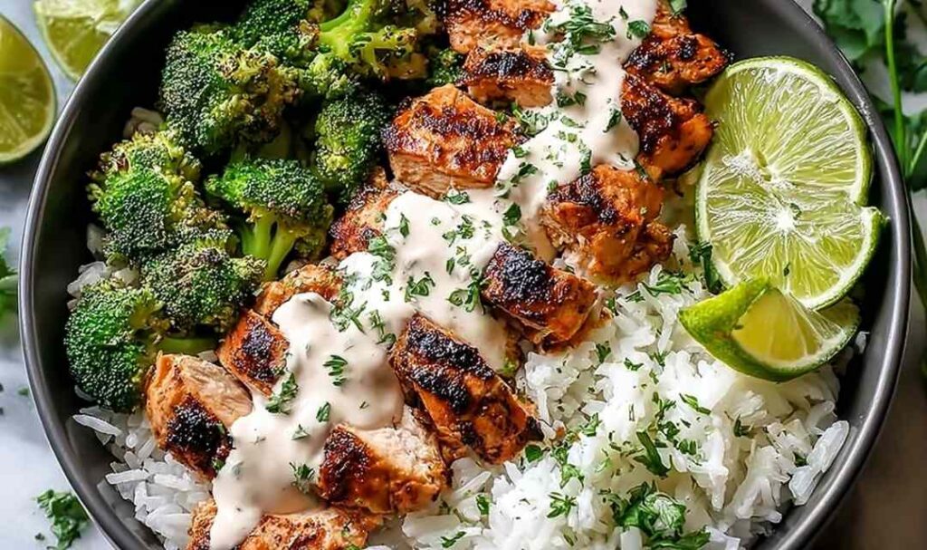 Chicken and broccoli bowls with creamy garlic sauce served over rice in white bowls