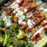 Chicken and broccoli bowls with creamy garlic sauce served over rice in white bowls