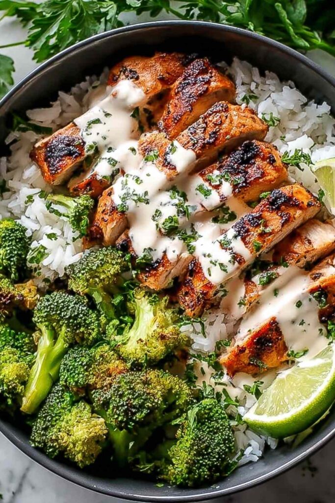 Chicken and broccoli bowls with creamy garlic sauce served over rice in white bowls