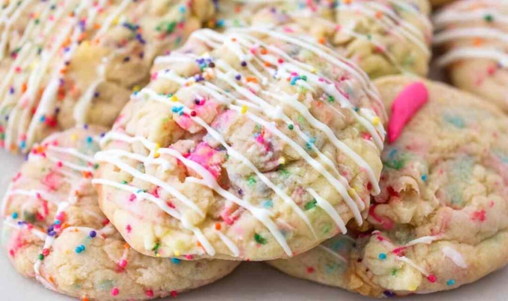 Circus Animal Stuffed Cookies with pink frosting and colorful nonpareils on white plate