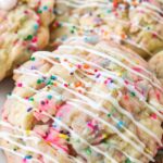 Circus Animal Stuffed Cookies with pink frosting and colorful nonpareils on white plate