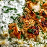 Dump and bake chicken tzatziki casserole in baking dish topped with melted cheese and fresh herbs