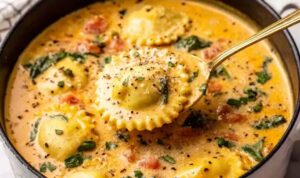 Creamy Ravioli Soup Recipe Creamy ravioli soup in white bowl topped with fresh basil and parmesan cheese