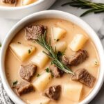 Bowl of creamy steak and potato soup with tender beef cubes