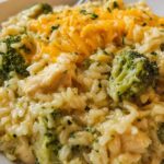 Crockpot cheesy chicken broccoli rice with melted cheddar