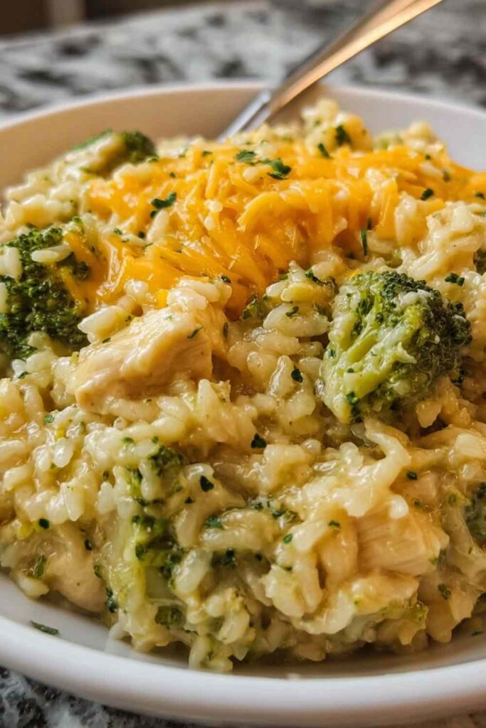 Crockpot cheesy chicken broccoli rice with melted cheddar
