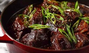 Korean Pot Roast Recipe Korean pot roast with sesame seeds and green onions on white rice
