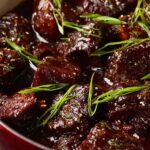 Korean pot roast with sesame seeds and green onions on white rice