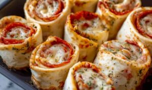 Easy Pizza Roll Ups on baking sheet with melted cheese and golden brown dough