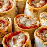 Easy Pizza Roll Ups on baking sheet with melted cheese and golden brown dough