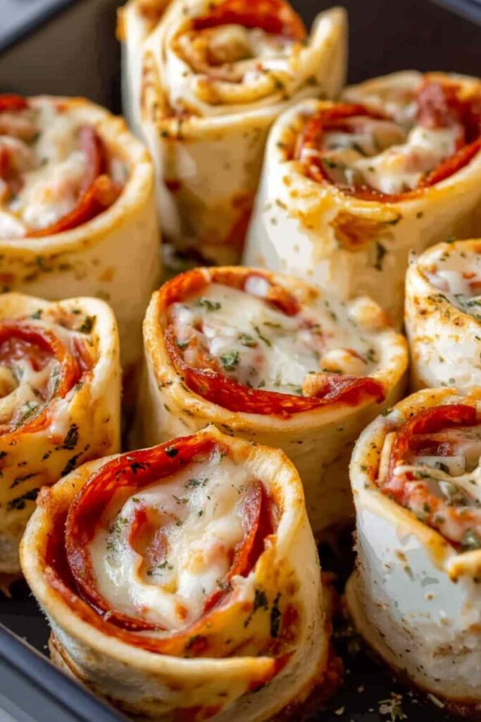 Easy Pizza Roll Ups on baking sheet with melted cheese and golden brown dough