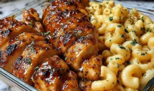 High protein honey garlic butter chicken with mac and cheese on a white plate
