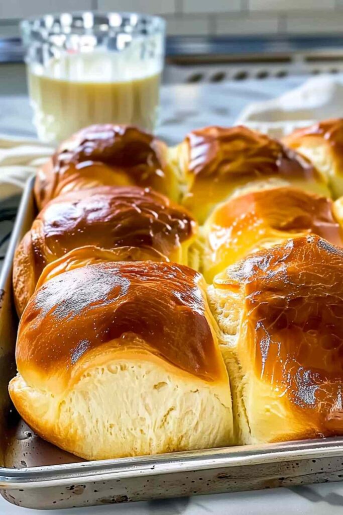 Golden brown milk brioche loaf fresh from the oven on cooling rack