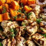 Maple Dijon Chicken Sweet Potato Bowls in white bowl with fresh spinach and garnish