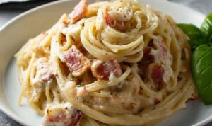 Michael Symon carbonara in white bowl with crispy guanciale and black pepper