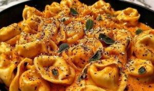One Pot Spicy Garlic Butter Chicken Tortellini in a large pot with melted cheese and fresh parsley