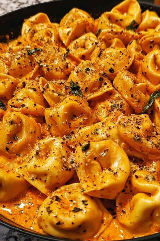One Pot Spicy Garlic Butter Chicken Tortellini in a large pot with melted cheese and fresh parsley