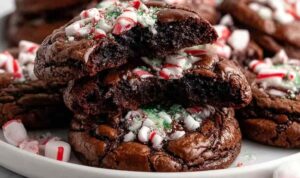 Peppermint brownie cookies with chocolate chips and crushed candy canes on cooling rack