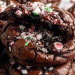 Peppermint brownie cookies with chocolate chips and crushed candy canes on cooling rack