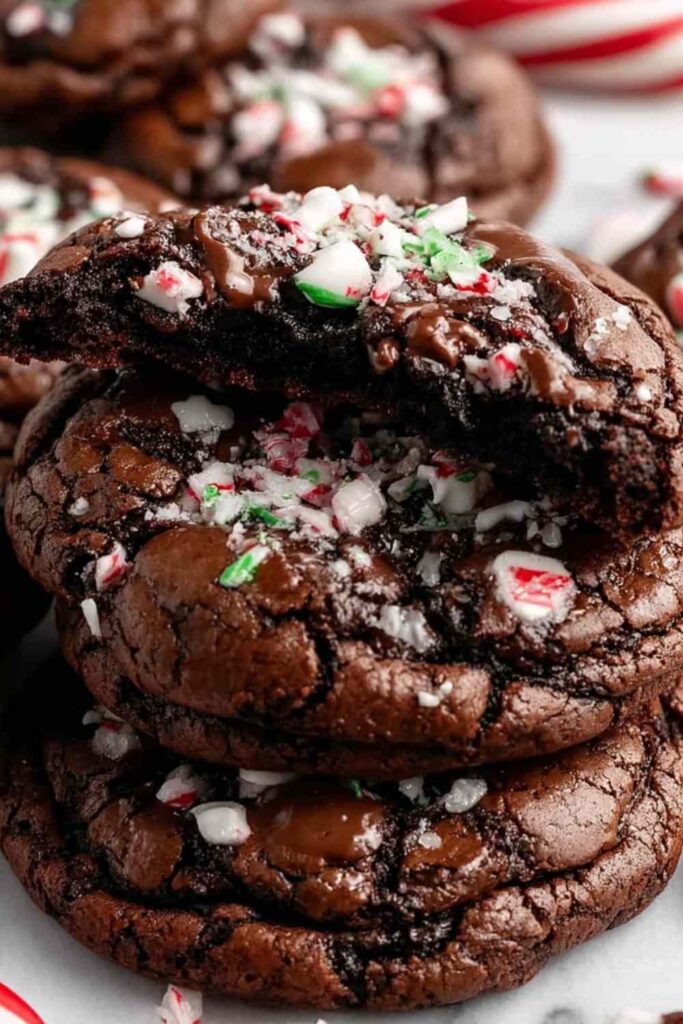 Peppermint brownie cookies with chocolate chips and crushed candy canes on cooling rack