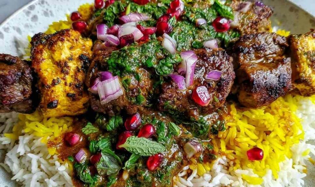 Persian Shish Andaz grilled meat skewers with bell peppers and onions on white platter