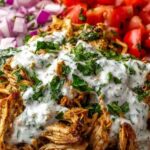 Slow cooker chicken shawarma shredded in a slow cooker with spices and onions