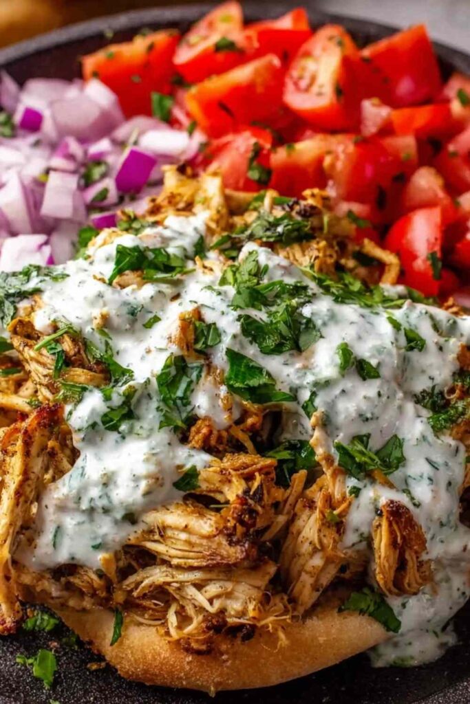 Slow cooker chicken shawarma shredded in a slow cooker with spices and onions