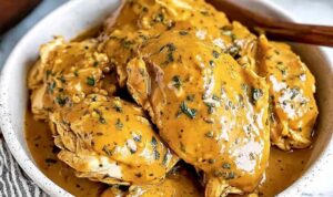 Slow cooker honey mustard chicken shredded in creamy sauce in crockpot