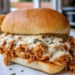 Slow Cooker Parmesan Garlic Chicken Sandwiches on toasted rolls with melted mozzarella cheese