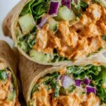 BBQ Grilled Chicken Wraps cut in half showing grilled chicken strips with BBQ sauce, fresh vegetables, and ranch dressing wrapped in flour tortilla
