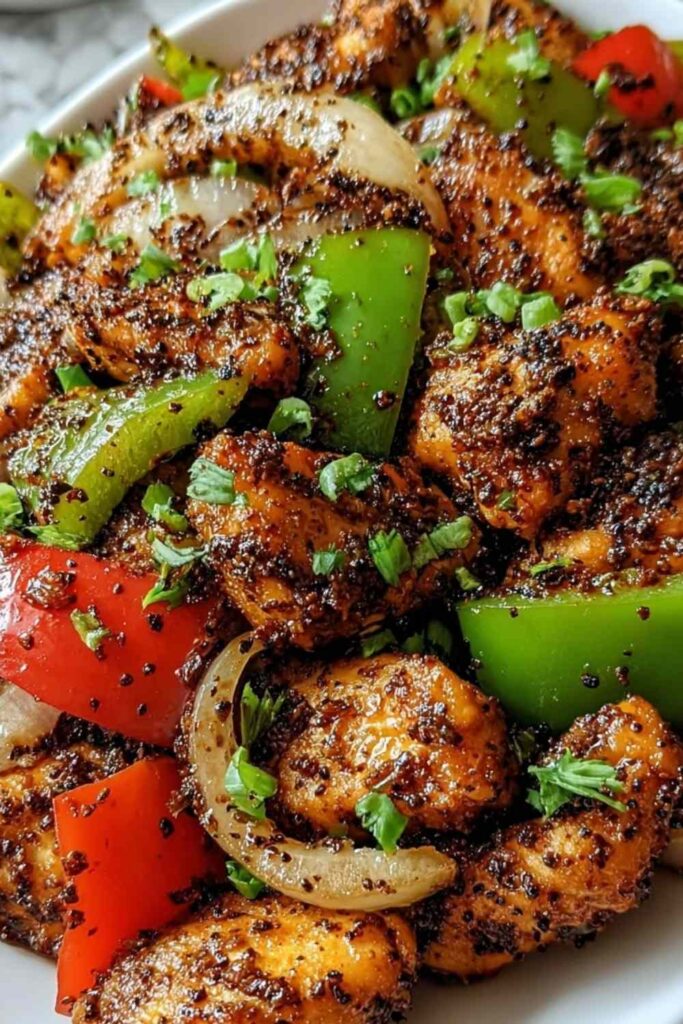 Black Pepper Chicken 6 Black pepper chicken stir-fry with bell peppers and green onions in a skillet