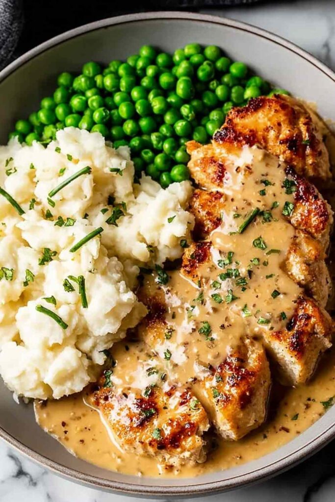 Creamy Boursin Chicken skillet with garlic herb sauce and fresh parsley garnish