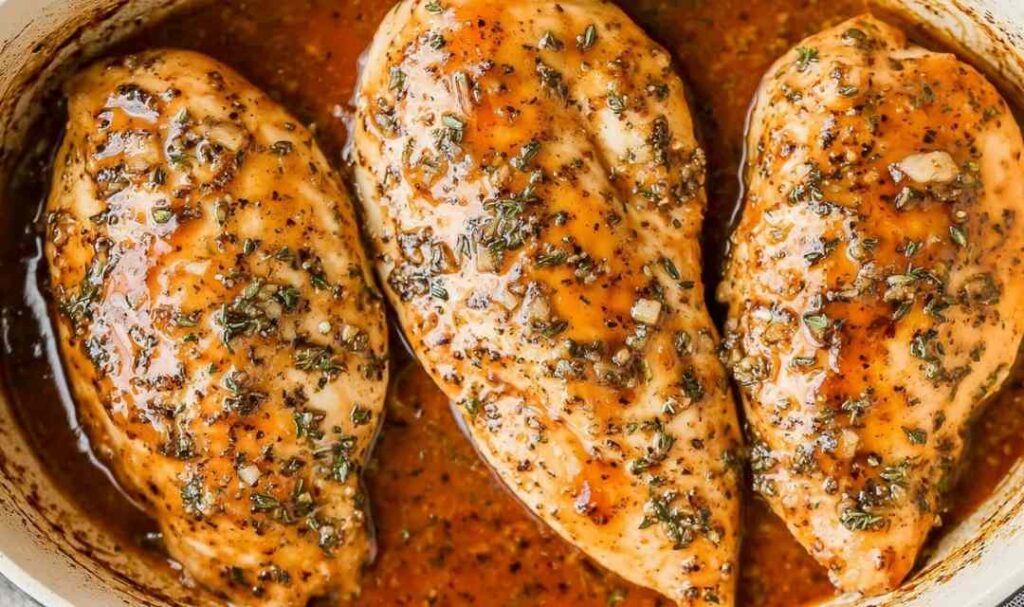 Brown sugar garlic chicken on white plate with glossy caramelized glaze and rice