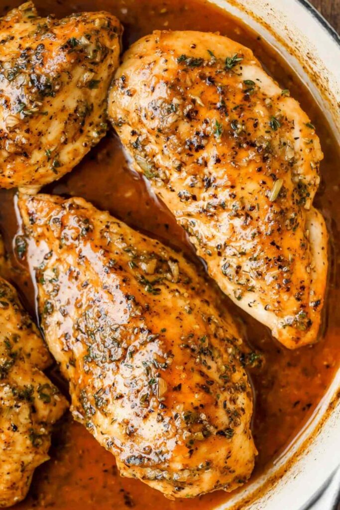 Brown sugar garlic chicken on white plate with glossy caramelized glaze and rice