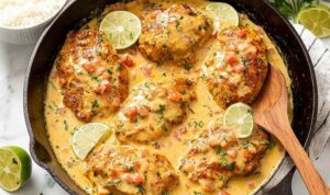 Cajun Chicken with Creamy Sauce Cajun Chicken in creamy sauce with tomatoes served in cast iron skillet with rice