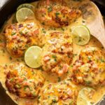 Cajun Chicken in creamy sauce with tomatoes served in cast iron skillet with rice