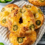Golden brown jalapeno bagels with everything seasoning on cooling rack