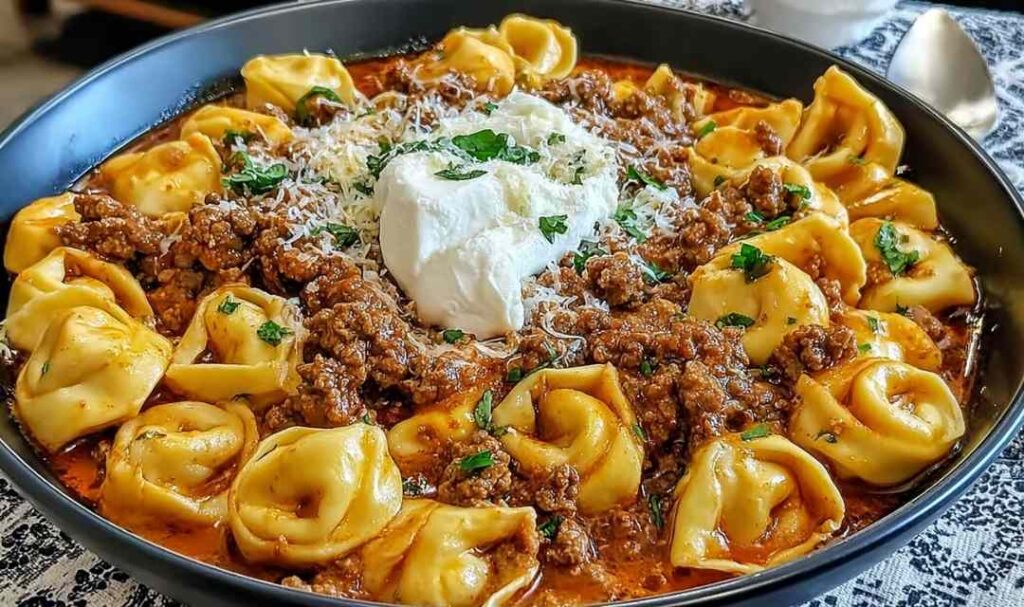 Cheesy Beef Enchilada Tortellini 5 Cheesy beef enchilada tortellini in a skillet topped with melted Mexican cheese and fresh cilantro