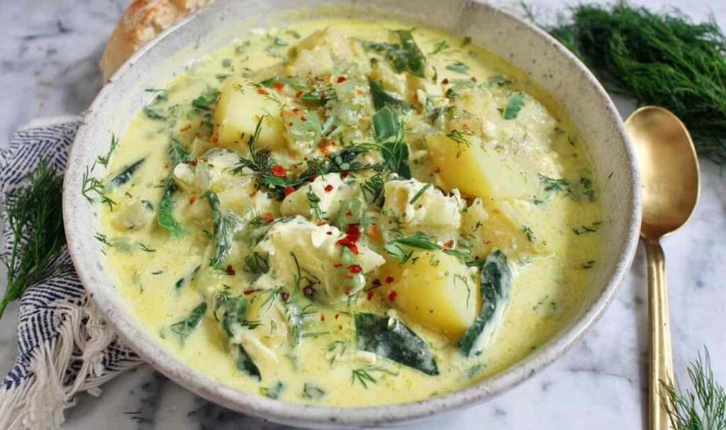 Chunky Potato Dill Soup 5 Chunky potato dill soup in a white ceramic bowl topped with fresh dill sprigs and a swirl of coconut milk