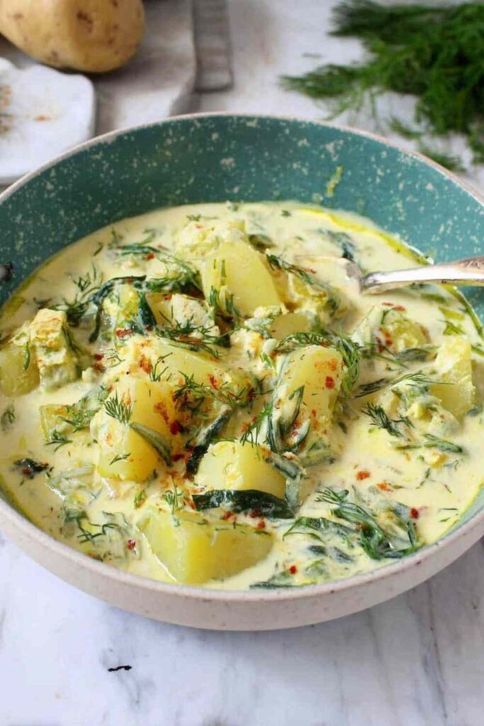 Chunky Potato Dill Soup 6 Chunky potato dill soup in a white ceramic bowl topped with fresh dill sprigs and a swirl of coconut milk