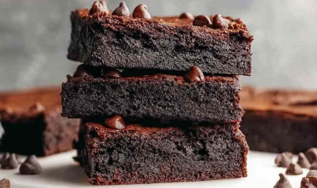 Fudgy cottage cheese brownies cut into squares on white plate with fork