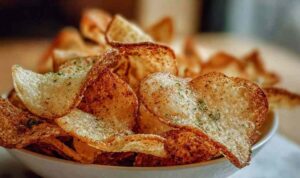 Protein Cottage Cheese Chips: The Crispy High-Protein Snack You'll Make on Repeat Crispy golden Protein Cottage Cheese Chips on white plate with bowl of salsa