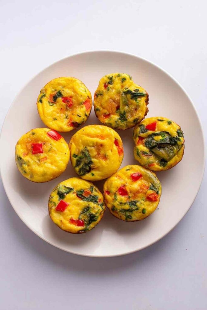 Cottage cheese egg bites in muffin tin fresh from oven with golden tops