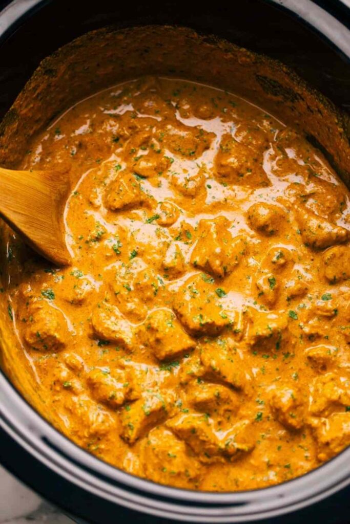 Crockpot Butter Chicken 6 Crockpot butter chicken served over basmati rice with warm naan and fresh cilantro garnish