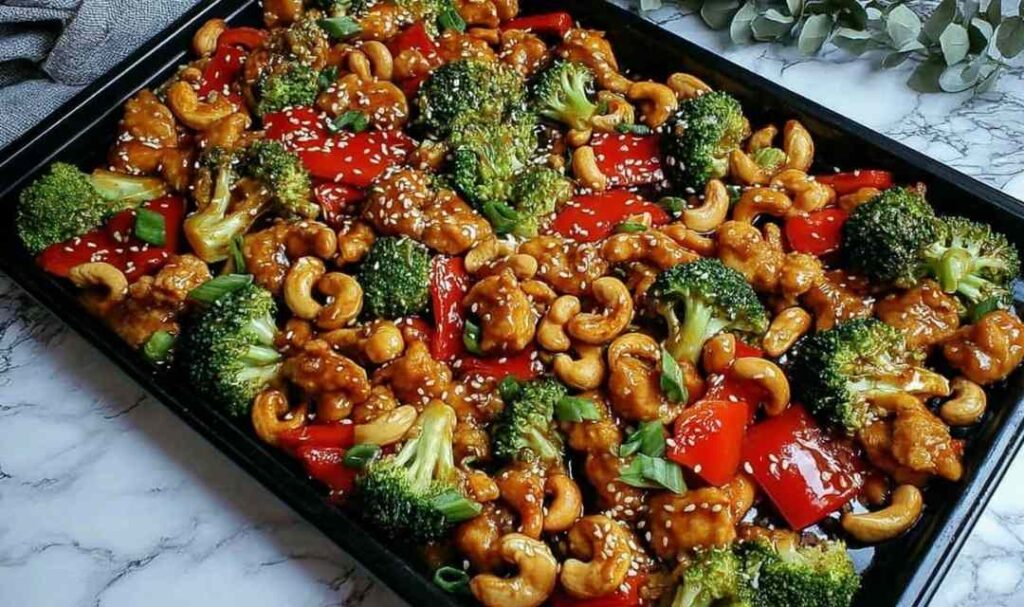 Sheet Pan Cashew Chicken: A High-Protein, One-Pan Wonder 5 Sheet pan cashew chicken with broccoli bell peppers and cashews on a baking sheet